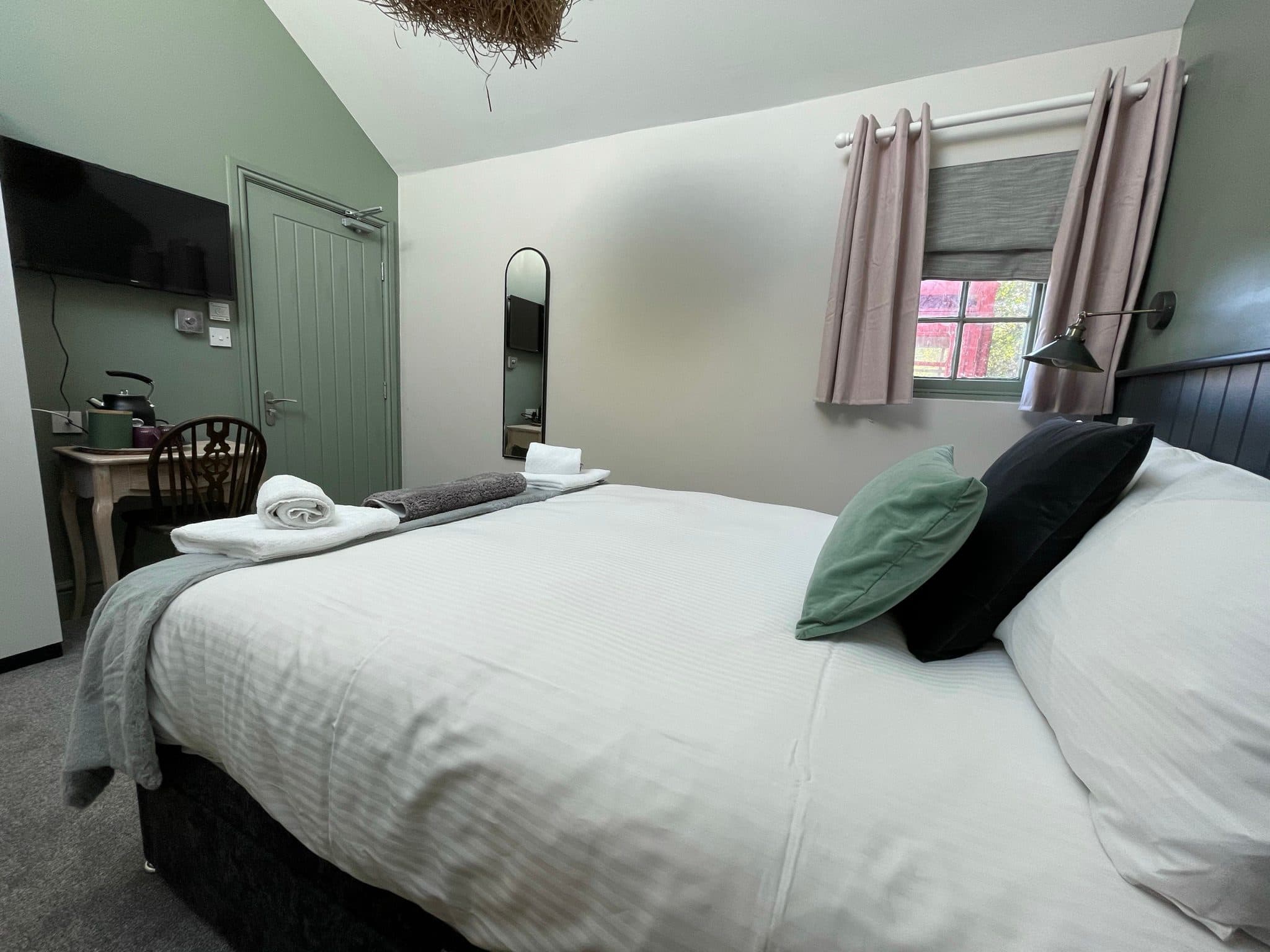 Stable-style guest room with willow lamp and desk